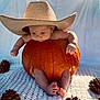baby, pumpkin, hat, straw_hat, pine_cone, blanket, barefoot, cute, fall, autumn, infant, portrait, outdoor, seasonal, child, natural_light, cozy, orange, texture, curious