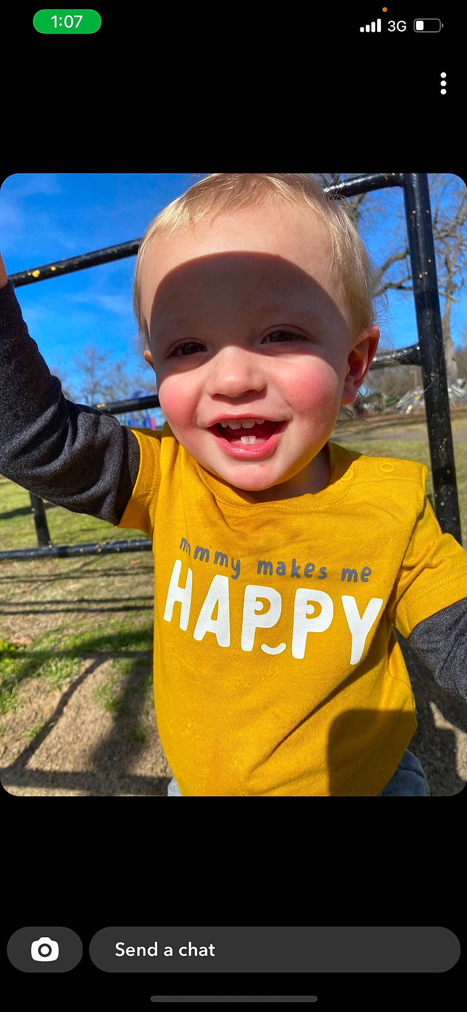 Ruger is registered to the contest to win money with this photo: baby, baby_toddler_clothing, cheek, cool, finger, gesture, grass, hand, happy, leisure, nose, person, recreation, sky, sleeve, smile, swing, t_shirt, thumb, toddler