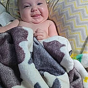 Gracelynn is registered to the contest to win money with this photo: baby, bed, blanket, chevron_pattern, child, cute, expression, face, happy, indoors, infant, lying_down, pillow, portrait, skin, smile, soft_texture, toddler, wrapped, young_child