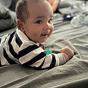 Dsean is registered to the contest to win money with this photo: baby, bed, blanket, bodypart, clothing, couch, crawling, face, finger, furniture, hand, happy, head, newborn, person, photography, portrait, shirt, sitting, smile