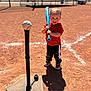 Celina is registered to the contest to win money with this photo: toddler, child, baseball, baseball_bat, baseball_tee, sports, outdoor, sunlight, shadow, dirt_field, red_hoodie, black_pants, sneakers, smiling, playing, young_child, recreation, daytime, field, fun