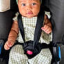 baby, child, car_seat, green_bow, green_outfit, straps, sitting, cute, portrait, infant, face, headband, clothing, hands, feet, indoor, secure, looking_at_camera, expression, closeup