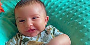 Colton is registered to the contest to win money with this photo: baby, child, smiling, cushion, animal_print, diaper, blue, pink, blanket, hair, happy, indoor, toddler, sibling, cute, face, person, clothing, soft_texture, playful