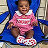 Delijah joined the competition — help win amazing prizes! baby, child, smiling, pigtails, blue_chair, red_checkered_dress, polka_dot_shoes, outdoor, concrete_floor, necklace, cute, happy, portrait, infant, person, sitting, clothing, fashion, black_hair, accessory
