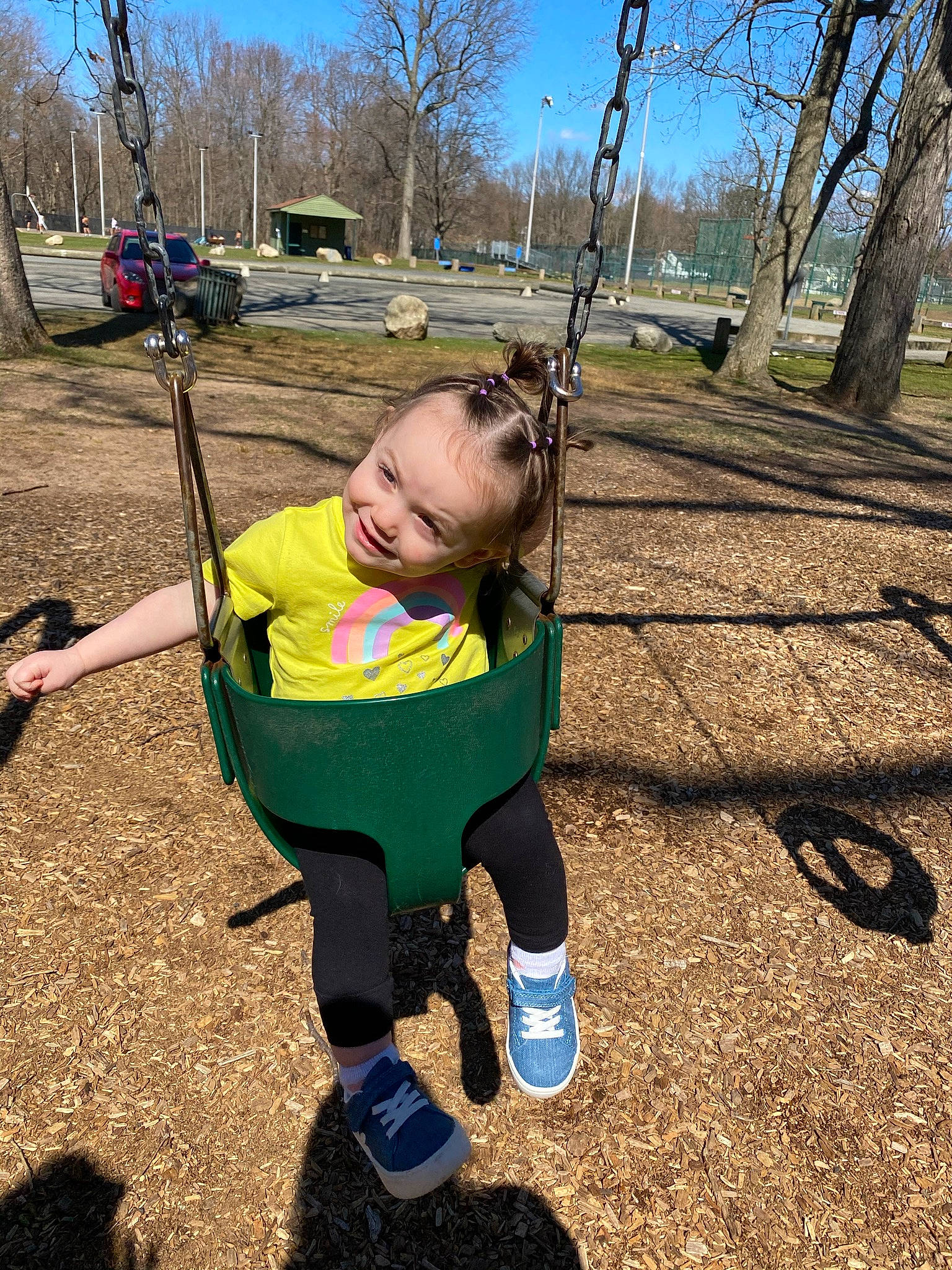 Lilyana joined the competition — help win amazing prizes! car, fun, grass, happy, joy, leaf, leisure, outdoor_play_equipment, people_in_nature, person, plant, playground, public_space, recreation, sky, smile, soil, swing, t_shirt, toddler