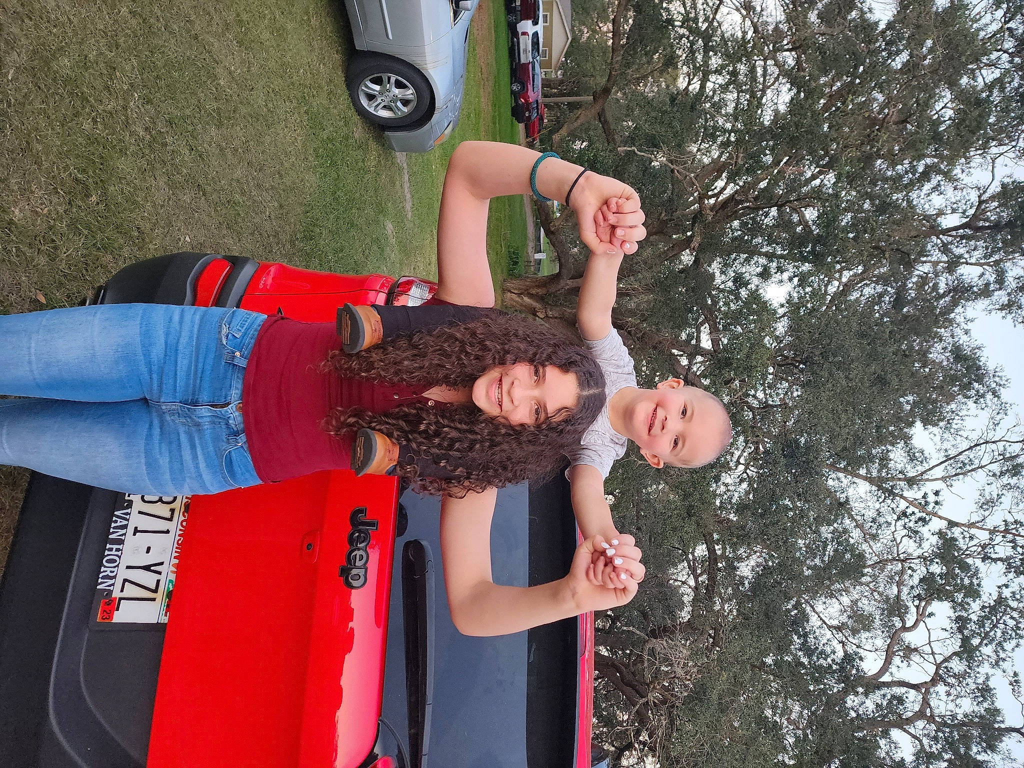 Destinee is registered to the contest to win money with this photo: automotive_lighting, automotive_tire, automotive_wheel_system, car, clothing, elbow, fender, fun, gesture, hat, human_leg, joy, leisure, person, recreation, t_shirt, thigh, tire, tree, vehicle