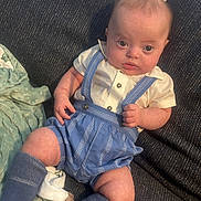 Warren joined the competition — help win amazing prizes! baby, infant, child, blue_suspender, white_shirt, blue_socks, couch, blanket, soft_texture, curious_expression, indoors, portrait, cute, chubby_cheeks, seated, looking_at_camera, fabric, cozy, casual_clothing, human