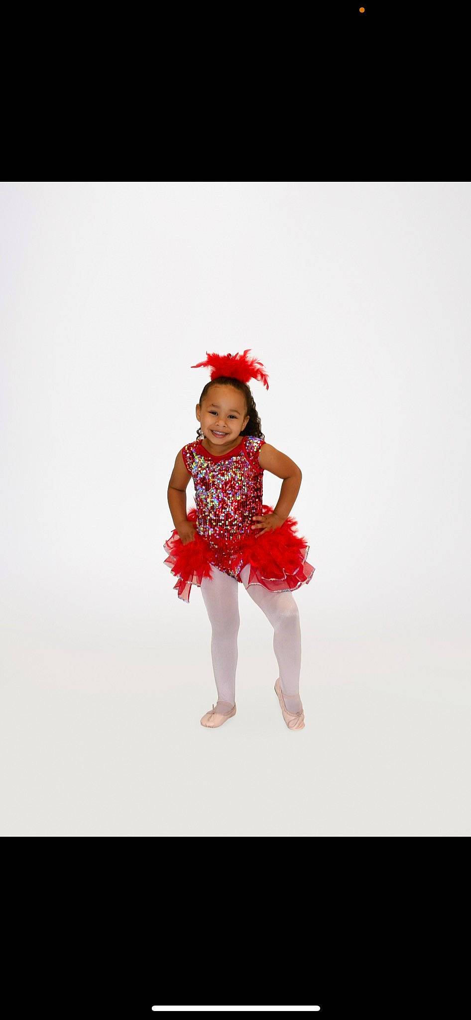 Amiyah is registered to the contest to win money with this photo: baby_toddler_clothing, barefoot, dance, entertainment, event, face, fashion_design, gesture, happy, human_leg, joy, magenta, one_piece_garment, performing_arts, person, sleeve, sportswear, standing, thigh, toddler