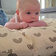 Ocean joined the competition — help win amazing prizes! baby, infant, pillow, hand, face, skin, eyes, mouth, chewing, indoor, bedroom, blanket, pattern, striped, furniture, room, curtains, painting, person, lying_down