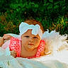 baby, child, infant, outdoor, portrait, lying_down, blanket, white_blanket, pink_clothing, headband, bow, grass, garden, greenery, nature, red_hair, face, looking_at_camera, photography, cute