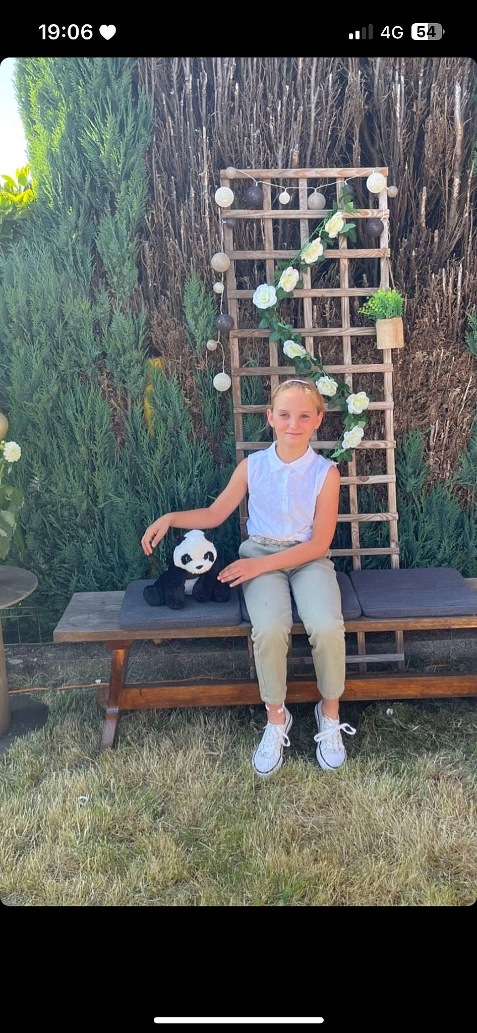 Keliyah participe au concours pour gagner de l'argent avec cette photo : backyard, ball, chair, eyewear, football, garden, grass, house, joy, knee, leisure, person, plant, sandal, shorts, sitting, sports_equipment, t_shirt, table, tree