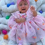 Miyori is registered to the contest to win money with this photo: baby, blanket, child, colorful, crying, cute, easter_eggs, fabric, flower, headband, infant, outdoor, pink_dress, portrait, sad, sitting, sock, soft, texture, toddler