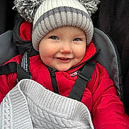 Murphy is registered to the contest to win money with this photo: baby, blanket, blue_eyes, cheeks, child, cozy, cute, face, hat, jacket, knitwear, outdoor, pom_pom, red_jacket, seatbelt, smile, stroller, toddler, warm, winter_clothing