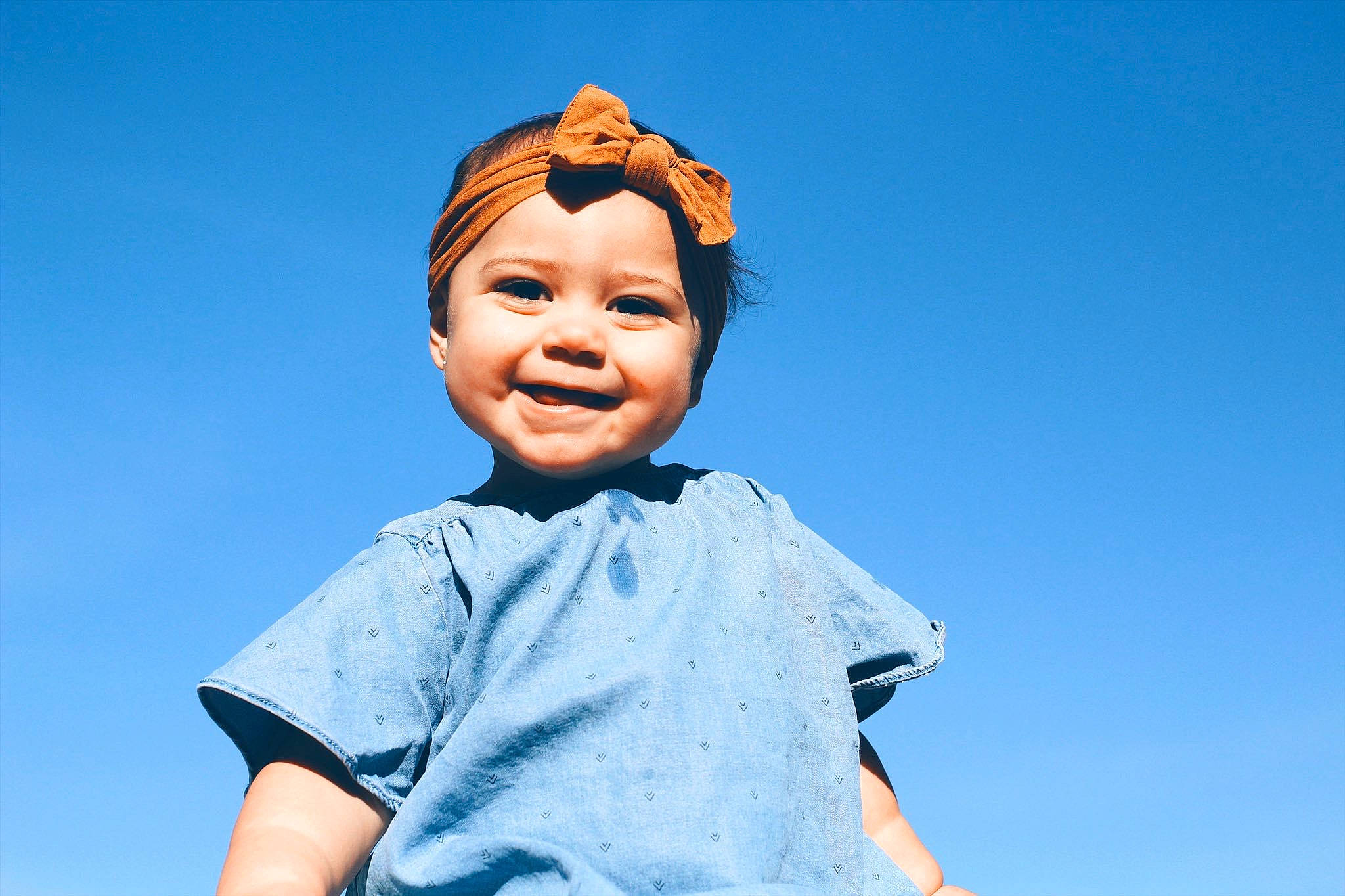 Adalina is registered to the contest to win money with this photo: blue, child, forehead, fun, gesture, happy, head, joy, person, photography, sky, smile, toddler, vacation