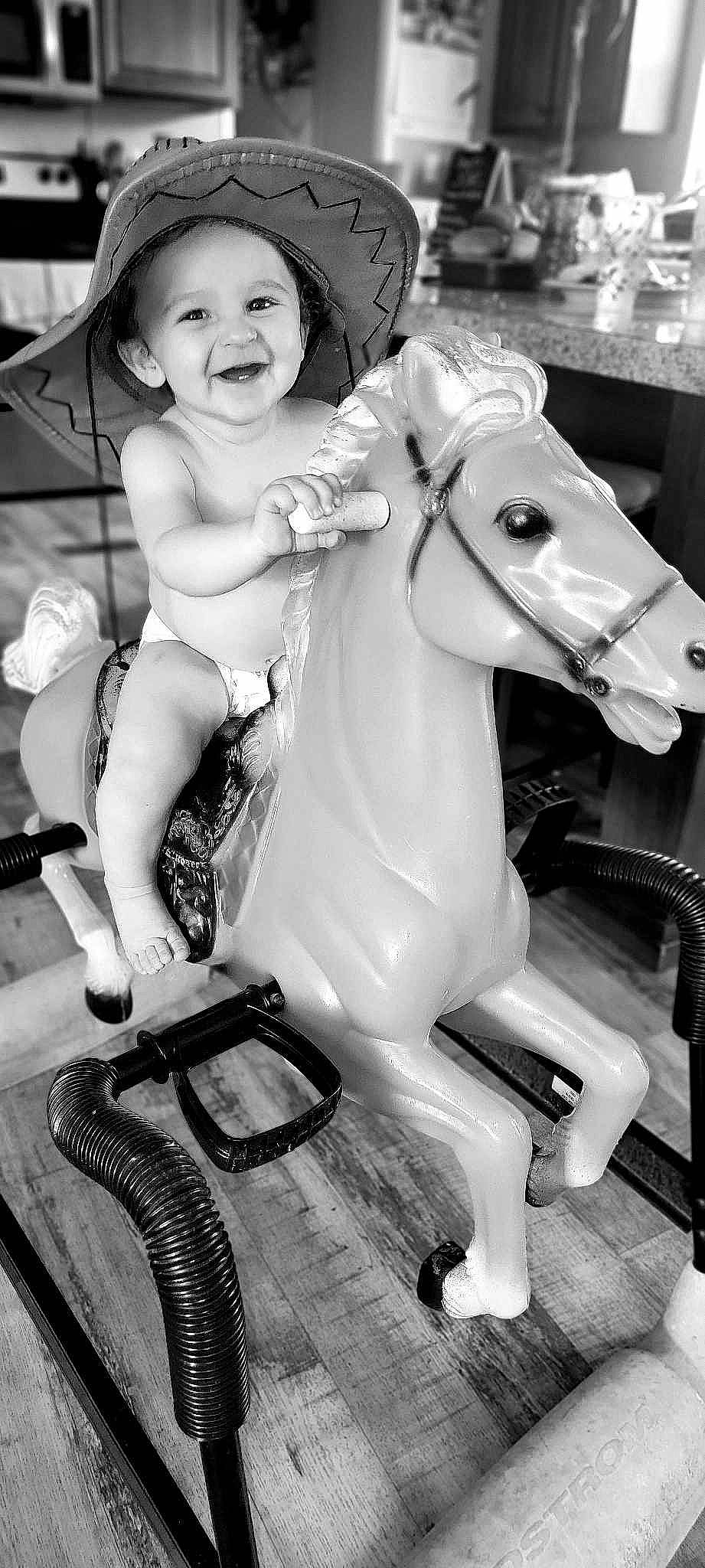 Mason is registered to the contest to win money with this photo: baby, bag, beauty, black, black_and_white, flash_photography, fun, happy, headwear, horse, horse_supplies, joy, luggage_and_bags, monochrome, monochrome_photography, person, photograph, smile, snapshot, style