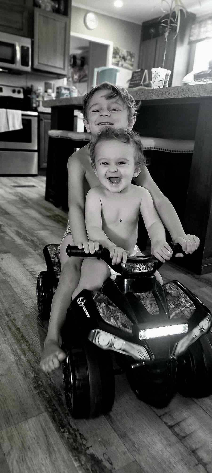 Evan is registered to the contest to win money with this photo: automotive_design, automotive_exterior, automotive_lighting, automotive_tire, automotive_wheel_system, black, black_and_white, fender, happy, joy, motor_vehicle, motorcycle, muscle, person, photograph, rim, shorts, smile, style, tire