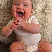 Georgia is registered to the contest to win money with this photo: baby, infant, smiling, happy, clapping, onesie, diaper, sitting, cute, chubby, skin, face, expression, hands, feet, texture, blanket, indoors, child, person