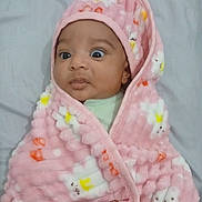 Enaya joined the competition — help win amazing prizes! baby, bed, blanket, child, cozy, cute, expression, flower_pattern, hand, indoors, infant, newborn, person, pink_blanket, portrait, sleepwear, soft_texture, warm, wide_eyes, wrapped