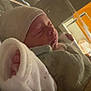 Mayron participe au concours pour gagner de l'argent avec cette photo : newborn, baby, sleeping, hospital, bassinet, blanket, hat, infant, indoors, cozy, warm_light, peaceful, child, wrapped, cute, bed, resting, face, closeup, soft