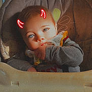 Kayde is registered to the contest to win money with this photo: baby, child, high_chair, blue_eyes, face, hand, clothing, indoor, sitting, cute, infant, digital_effect, devil_horns, playful, portrait, young_child, human, person, casual, expression