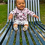 Janelle a rejoint le concours — aidez-le/la à gagner de superbes lots ! baby, child, smiling, outdoor, bench, blue_bench, grass, minnie_mouse, clothing, cute, happy, sitting, person, infant, sock, playful, nature, young_child, portrait, daylight