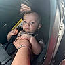 Mateo joined the competition — help win amazing prizes! baby, child, car_seat, seatbelt, hand, adult, bracelet, blue_eyes, sunlight, interior, car, safety, infant, portrait, person, clothing, seat, straps, cute, toddler