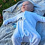 Mateo is registered to the contest to win money with this photo: baby, blanket, blue_eyes, child, face, fall, footed_pajamas, grass, head, infant, leaves, nature, onesie, outdoor, pacifier_clip, peaceful, portrait, relaxing, sleepwear, soft_texture
