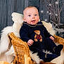 Mateo joined the competition — help win amazing prizes! baby, child, smiling, wicker_chair, plush_toy, reindeer_toy, bear_toy, cushion, blanket, winter, fairy_lights, wooden_wall, portrait, soft_lighting, cozy, indoor, navy_clothing, teddy_bear, happy, cute