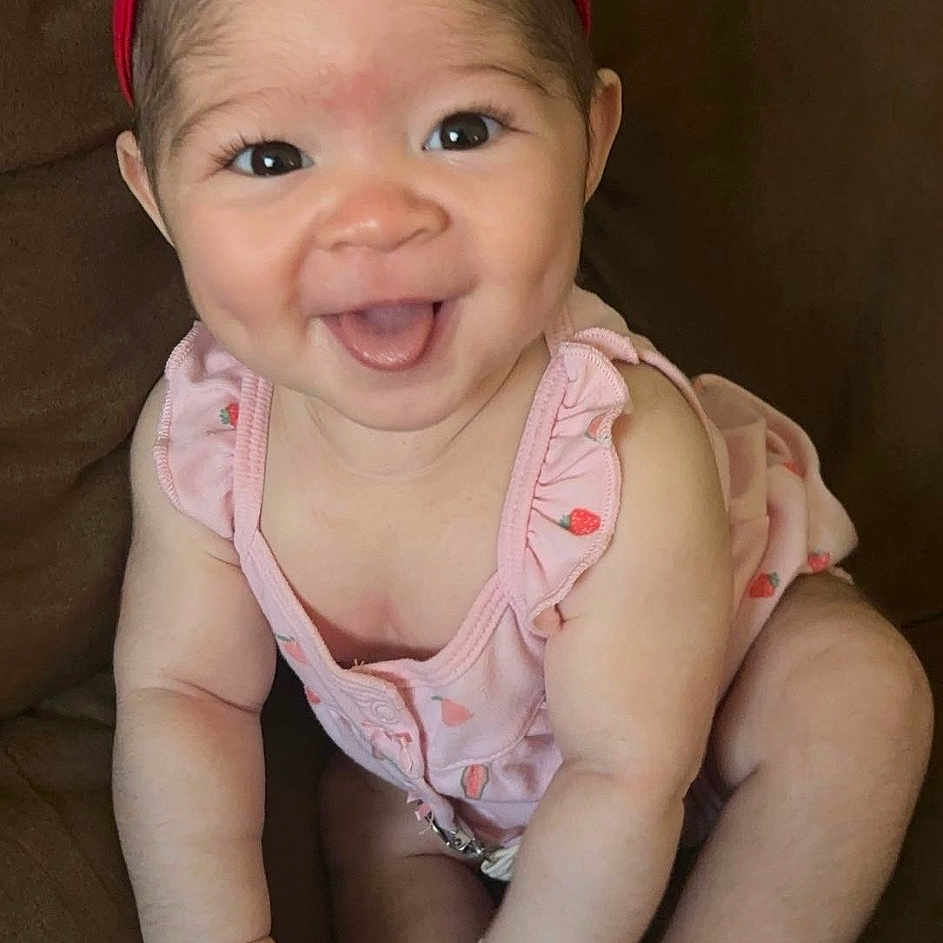 Aaliyah joined the competition — help win amazing prizes! accessories, baby, babylaughing, bodypart, couch, cushion, face, furniture, happy, head, homedecor, jewelry, laughing, necklace, newborn, person, photography, portrait, sitting, smile