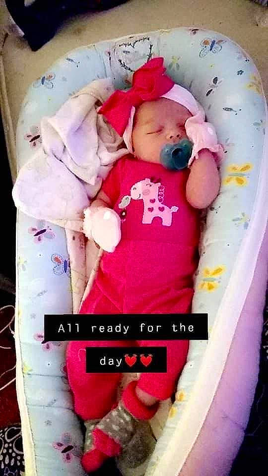 Ellie is registered to the contest to win money with this photo: baby, baby_products, baby_safety, baby_sleeping, baby_toddler_clothing, child, comfort, font, happy, linens, magenta, person, pink, product, room, sitting, sleeve, toddler