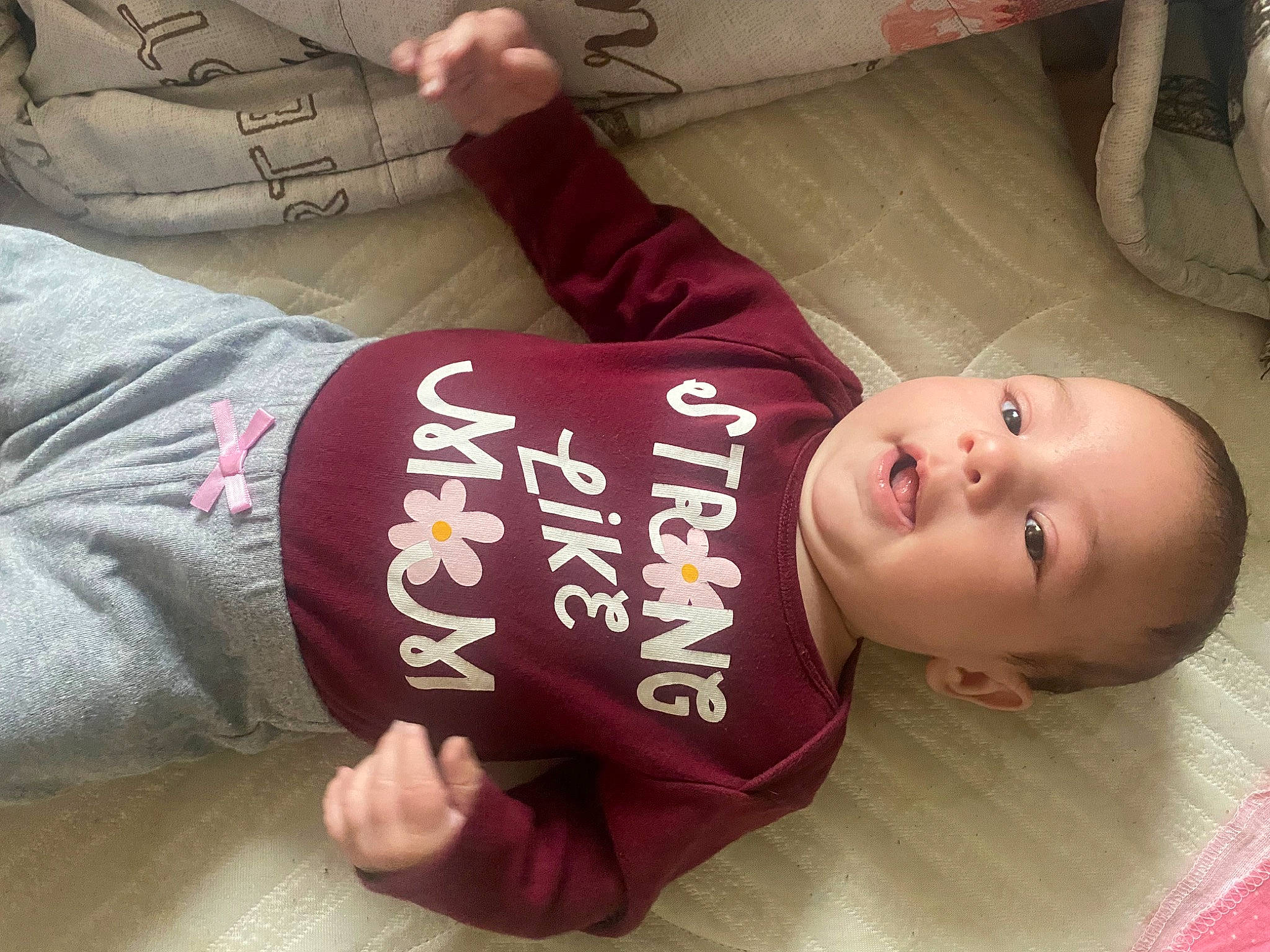 Rayleigh is registered to the contest to win money with this photo: baby, baby_toddler_clothing, cheek, child, comfort, facial_expression, finger, flooring, font, hand, nail, person, plant, room, sitting, skin, sleeve, table, thumb, toddler