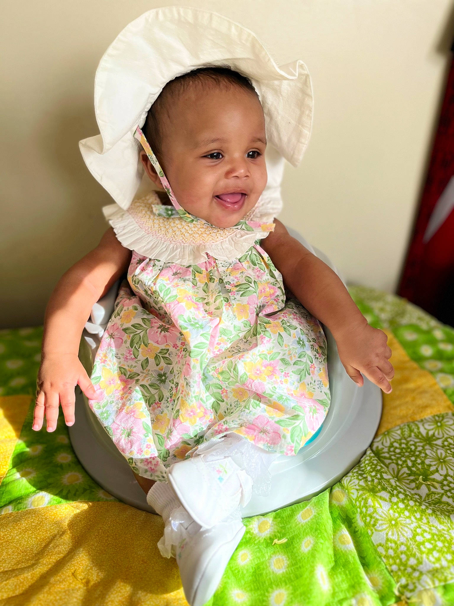 Aila is registered to the contest to win money with this photo: baby, baby_toddler_clothing, child, comfort, dress, fashion_accessory, fashion_design, fun, grass, green, happy, linens, magenta, outerwear, pattern, person, sitting, sleeve, smile, toddler