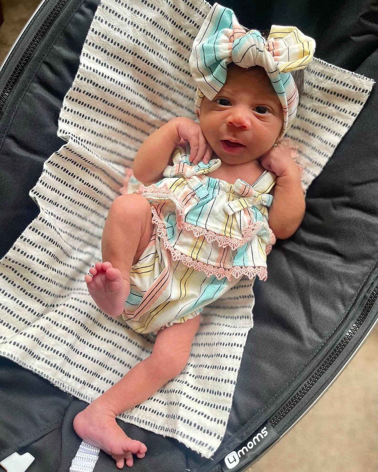 Blyss joined the competition — help win amazing prizes! baby, baby_products, baby_toddler_clothing, cap, child, comfort, couch, finger, headwear, human_leg, lap, leg, pattern, people, person, pink, sitting, skin, sun_hat, textile