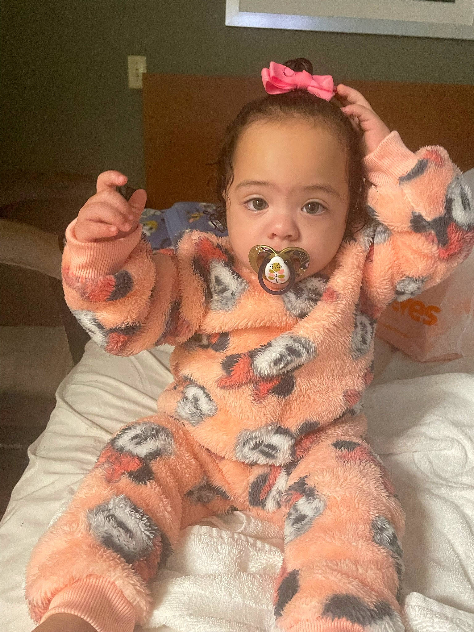 Bridget is registered to the contest to win money with this photo: arm, baby, baby_toddler_clothing, cheek, child, comfort, eye, finger, fun, gesture, hand, head, human_body, mouth, person, pink, skin, stuffed_toy, textile, thumb