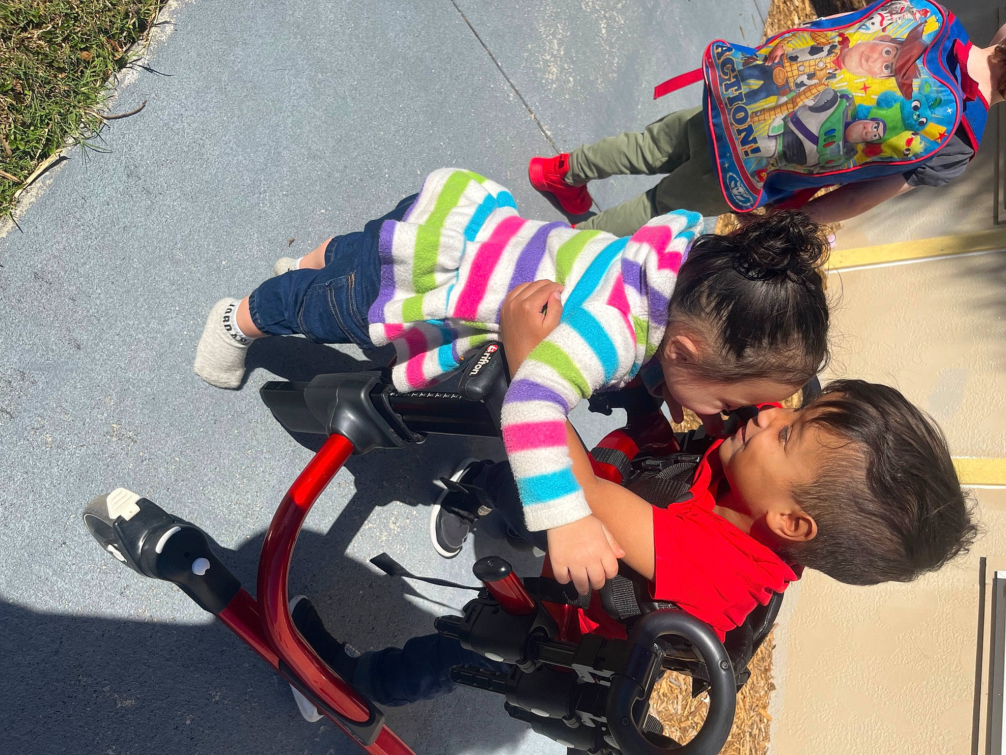 Bridget is registered to the contest to win money with this photo: asphalt, baby, baby_carriage, baby_products, child, event, fun, leisure, person, play, recreation, road, road_surface, sidewalk, sitting, tire, toddler, wheel