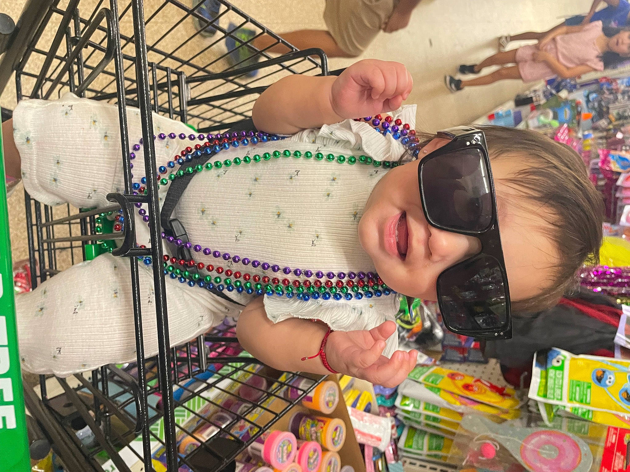 Mia is registered to the contest to win money with this photo: abdomen, black_hair, chest, child, event, eyewear, fashion, fun, glasses, goggles, happy, human_leg, jewellery, leisure, pattern, person, sunglasses, thigh, toddler, trunk