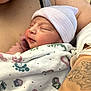baby, blanket, childbirth, clothing, face, glove, hat, head, newborn, person, photography, portrait, skin, sleeping, tattoo