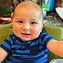 Jacob is registered to the contest to win money with this photo: baby, child, smiling, blue_striped_shirt, high_chair, happy, face, portrait, indoor, cute, infant, person, cheeks, eyes, short_hair, table, kitchen, background_blur, sitting, reaching_out