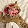 baby, child, smiling, costume, hood, bear, cute, infant, happy, face, blue_eyes, blanket, plush, clothing, portrait, lying_down, baby_garment, warm, toddler, zipped_jacket