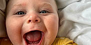 Robin joined the competition — help win amazing prizes! baby, child, face, smile, mouth_open, finger, polka_dot, yellow_clothing, blue_eyes, blanket, closeup, infant, happy, cute, portrait, skin, hand, indoors, soft_texture, baby_clothes