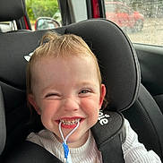 Lily joined the competition — help win amazing prizes! child, toddler, car_seat, smiling, happy, face, straps, clothing, window, rain, car, seatbelt, indoor, person, cute, playful, closeup, hair, expression, seat