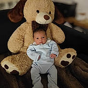 Zayn participe au concours pour gagner de l'argent avec cette photo : adorable, baby, blanket, blue_onesie, child, comfort, cozy, cuddly, cute, indoors, infant, plush, portrait, sitting, sleepwear, smiling, soft_toy, teddy_bear, toy, young