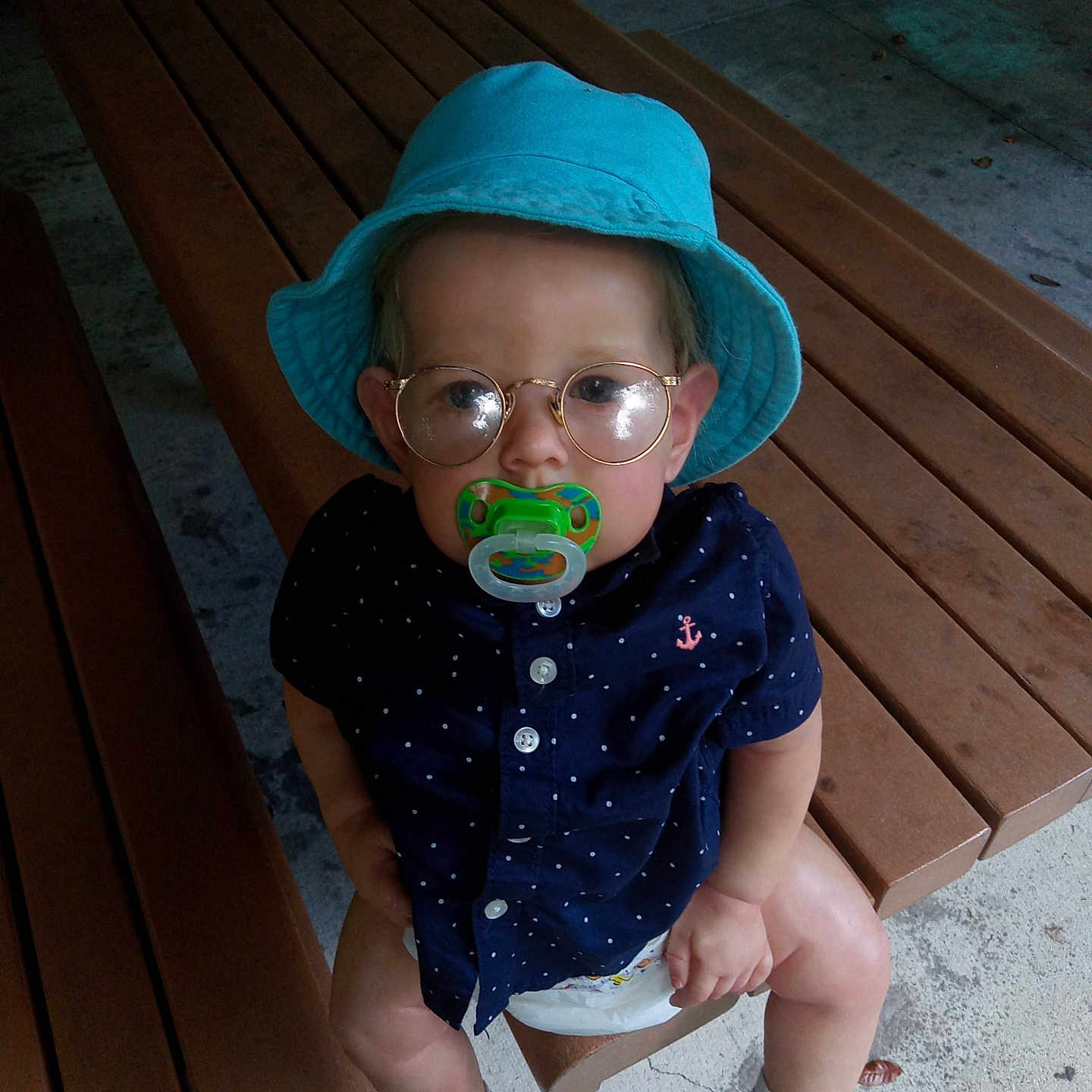 Thomas is registered to the contest to win money with this photo: accessories, baby, bench, cap, clothing, face, footwear, furniture, glasses, hat, head, hosiery, person, photography, portrait, shoe, shorts, sitting, sneaker, wood