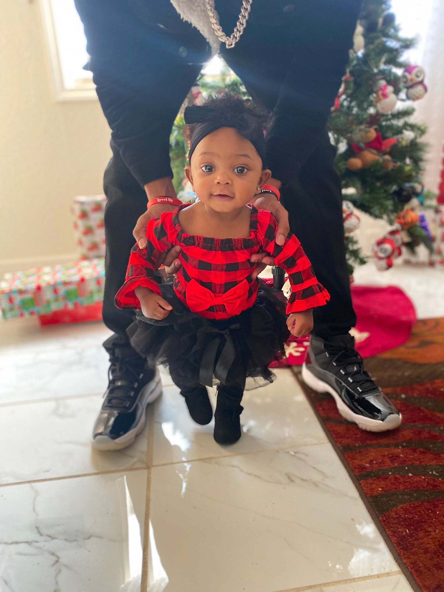 Kassidy is registered to the contest to win money with this photo: baby, baby_toddler_clothing, carmine, child, christmas, christmas_decoration, christmas_eve, christmas_ornament, christmas_tree, costume_accessory, floor, flooring, holiday, holiday_ornament, interior_design, person, red, shoe, toddler, tradition