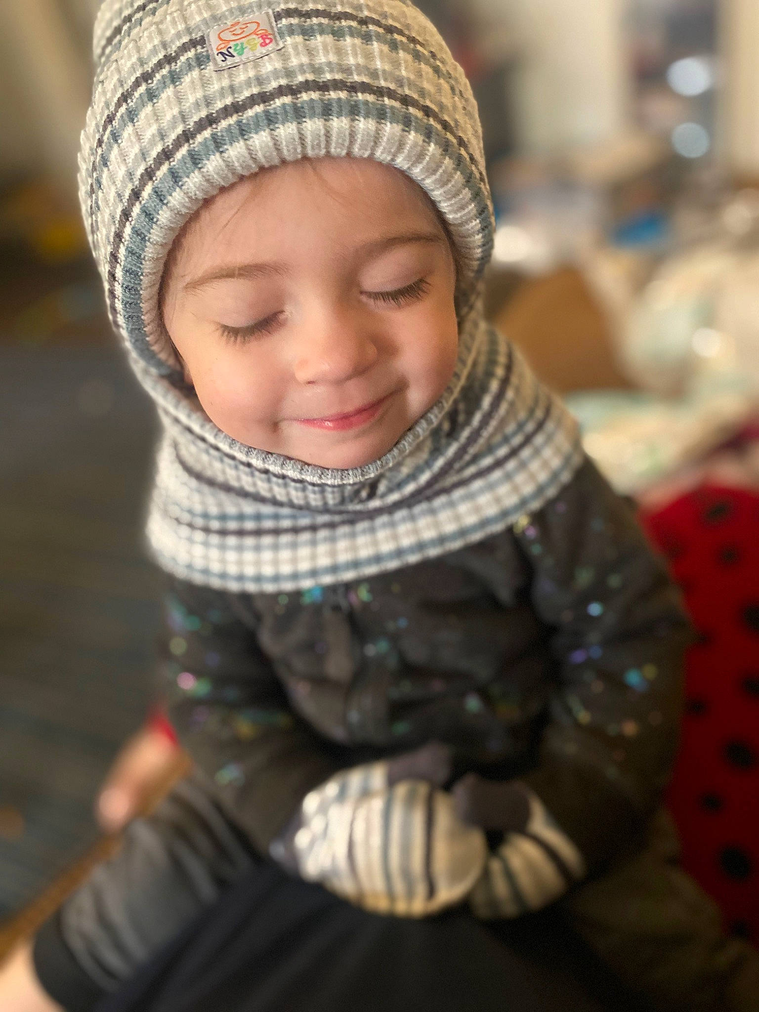 Kamari is registered to the contest to win money with this photo: cap, child, cool, eye, face, fashion_accessory, fun, happy, headgear, headwear, jacket, joy, knit_cap, pattern, people, person, shawl, smile, stole, toddler