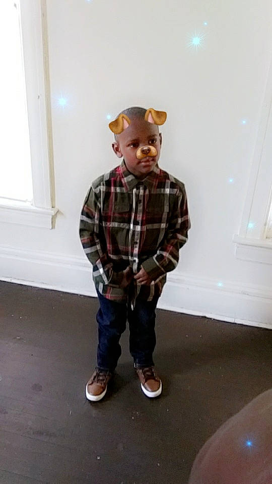 Javontae is registered to the contest to win money with this photo: arm, child, denim, design, footwear, headgear, joint, leg, male, outerwear, pattern, person, plaid, shoe, shoulder, sleeve, standing, tartan, textile, toddler