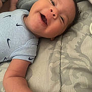 Kaziel joined the competition — help win amazing prizes! baby, infant, child, smiling, laughing, portrait, close_up, face, eyes, mouth, hair, skin, onesie, clothing, nike, blanket, bedding, indoor, cozy, happy