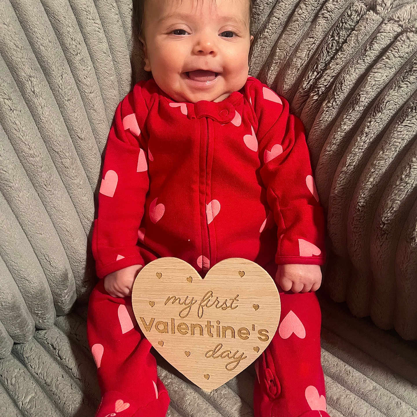 Maci is registered to the contest to win money with this photo: baby, blanket, clothing, couch, dress, face, formalwear, furniture, happy, head, homedecor, hosiery, laughing, pajamas, person, photography, portrait, sitting, smile, sock