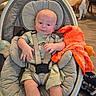 Aulcard is registered to the contest to win money with this photo: baby, infant, child, sitting, bouncer, baby_chair, harness, cushion, blanket, orange_blanket, cat, pet, indoors, home, wood_floor, portrait, face, wide_eyes, clothing, furniture