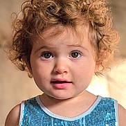 Gianna joined the competition — help win amazing prizes! toddler, child, curly_hair, blue_sequin_top, face, portrait, indoor, young_child, cute, eyes, expression, fashion, person, closeup, skin, hair, innocent, looking, warm_light, soft_background